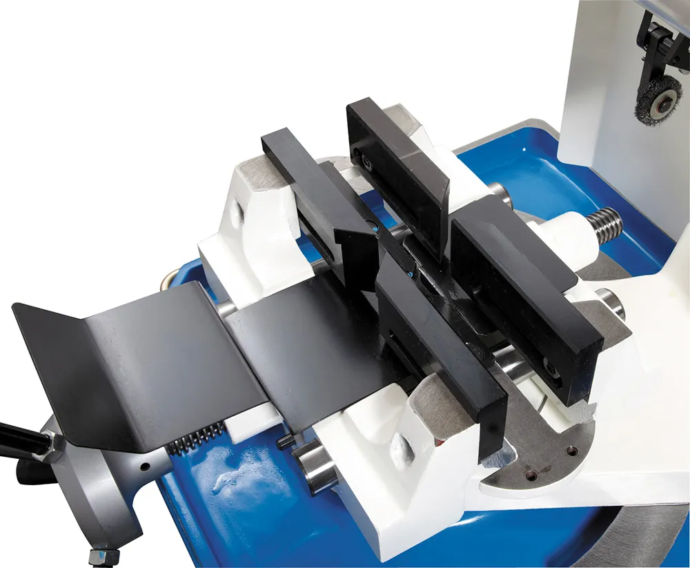 Cold saw machine clamping system securing workpiece for precision cutting